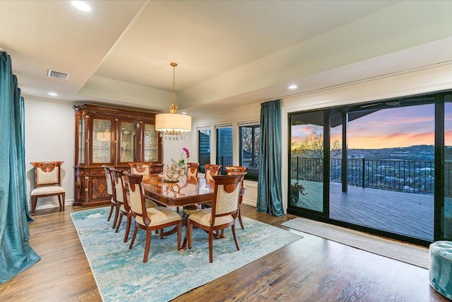 4732 Twin Valley Dr, Austin, TX 78731 - dining space with wood finished floors, recessed lighting, a chandelier, a tray ceiling, and baseboards