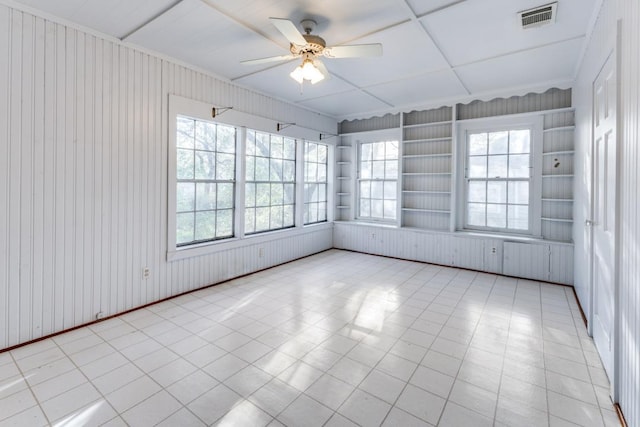 2710 Enfield Rd, Austin, TX 78703 - empty room featuring a ceiling fan, wood walls, visible vents, and a wealth of natural light