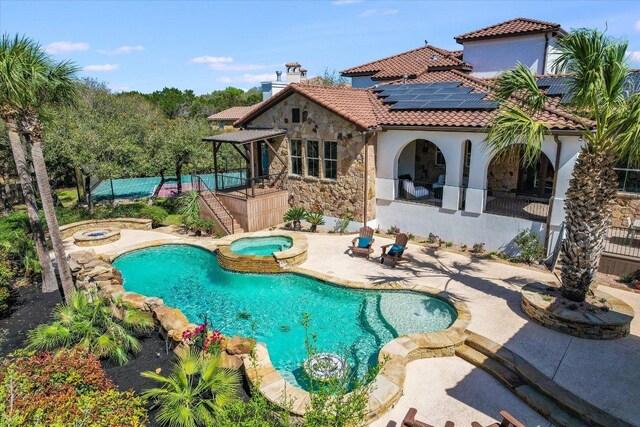 3312 Pearce Rd, Austin, TX 78730 - view of swimming pool with an in-ground hot tub, a patio area, and an outdoor fire pit