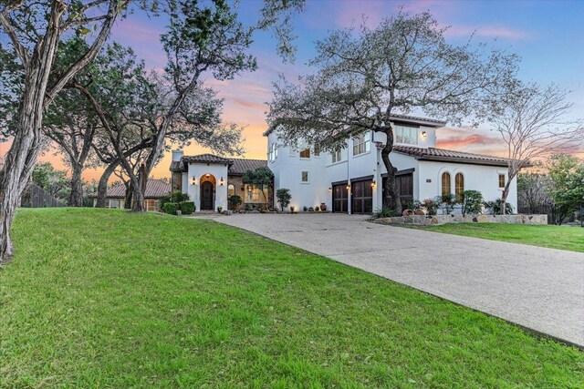 3312 Pearce Rd, Austin, TX 78730 - mediterranean / spanish-style house featuring a tile roof, driveway, stucco siding, a front lawn, and an attached garage