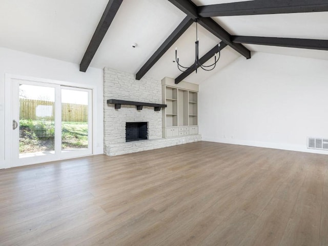 1403 E Applegate Dr, Austin, TX 78753 - unfurnished living room with a chandelier, wood finished floors, a stone fireplace, and baseboards