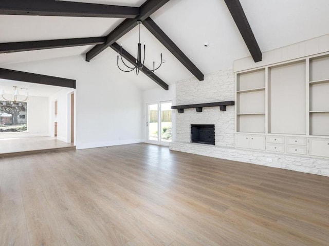 1403 E Applegate Dr, Austin, TX 78753 - unfurnished living room featuring a chandelier, wood finished floors, and a stone fireplace