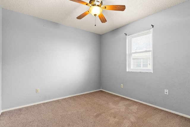 carpeted empty room with baseboards, a textured ceiling, and ceiling fan