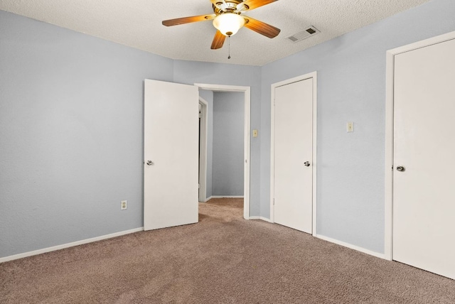 unfurnished bedroom with visible vents, baseboards, carpet flooring, a textured ceiling, and a ceiling fan