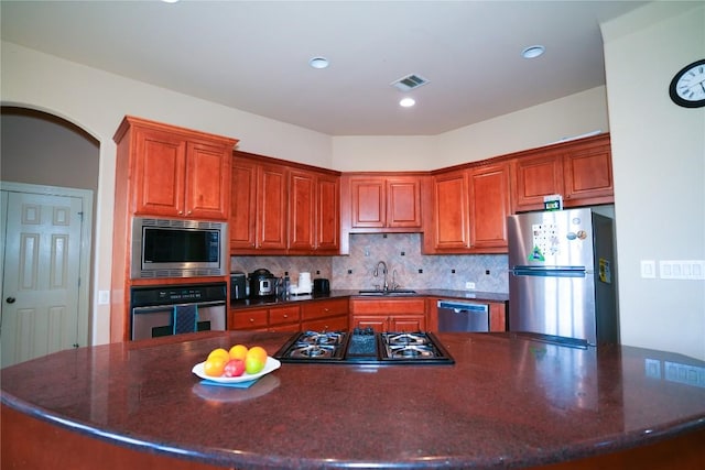 11608 Spicewood Pkwy Unit 38, Austin, TX 78750 - kitchen featuring stainless steel appliances, decorative backsplash, a large island, recessed lighting, and arched walkways