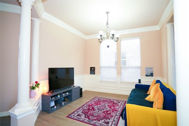 11608 Spicewood Pkwy Unit 38, Austin, TX 78750 - living room with decorative columns, a chandelier, wood finished floors, crown molding, and wainscoting