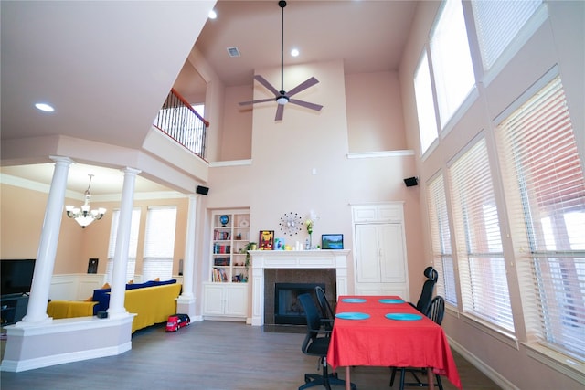 11608 Spicewood Pkwy Unit 38, Austin, TX 78750 - dining area featuring decorative columns, ceiling fan, a fireplace, wood finished floors, and healthy amount of natural light