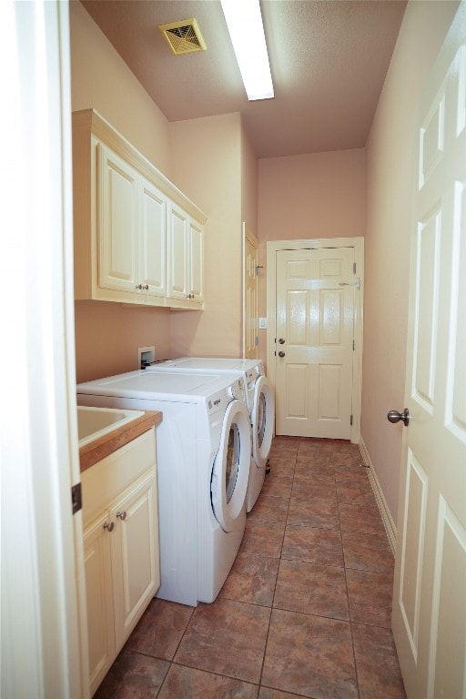 11608 Spicewood Pkwy Unit 38, Austin, TX 78750 - laundry room featuring cabinet space, washer and clothes dryer, and tile patterned flooring
