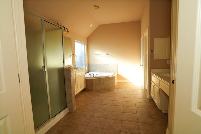 11608 Spicewood Pkwy Unit 38, Austin, TX 78750 - full bathroom with vanity, a shower stall, a bath, lofted ceiling, and tile patterned floors