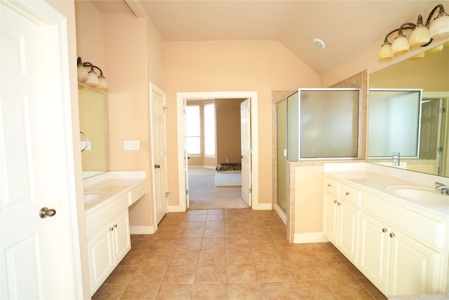 11608 Spicewood Pkwy Unit 38, Austin, TX 78750 - bathroom with a stall shower, two vanities, tile patterned flooring, and lofted ceiling