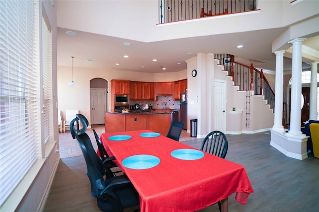 11608 Spicewood Pkwy Unit 38, Austin, TX 78750 - dining area with ornate columns, wood finished floors, arched walkways, and recessed lighting