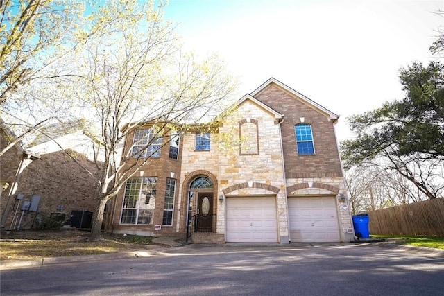 11608 Spicewood Pkwy Unit 38, Austin, TX 78750 - french country inspired facade with stone siding, an attached garage, asphalt driveway, and brick siding