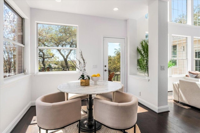 dining area with dark wood finished floors, baseboards, and recessed lighting