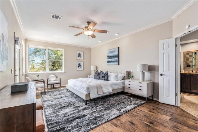 bedroom with ornamental molding, wood finished floors, and baseboards