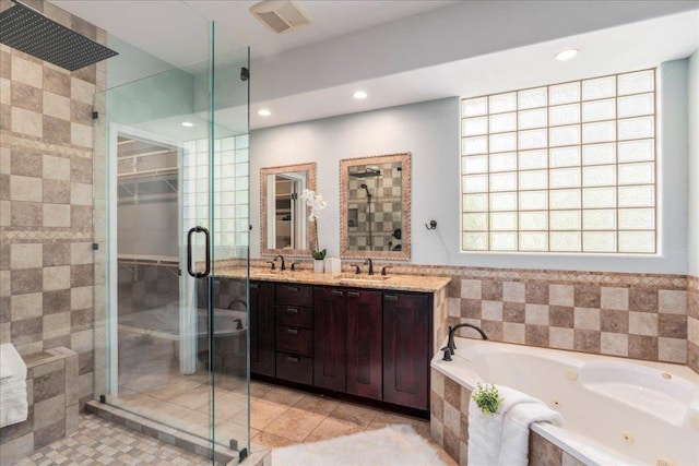 12413 Fairfax Ridge Pl, Austin, TX 78738 - bathroom with a tub with jets, a stall shower, double vanity, recessed lighting, and tile walls