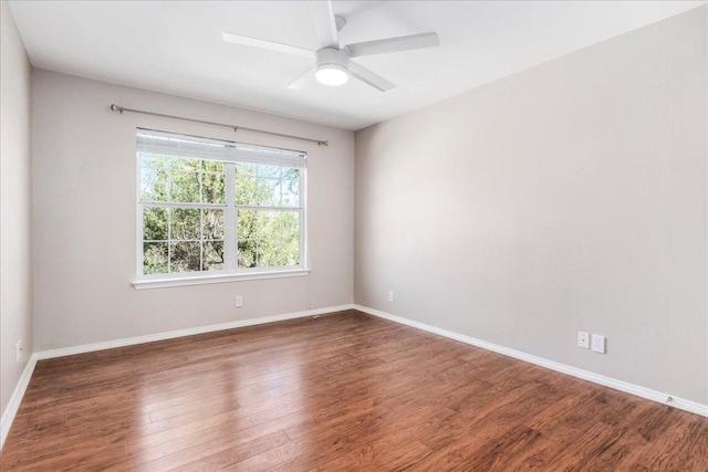 unfurnished room featuring wood finished floors, baseboards, and ceiling fan