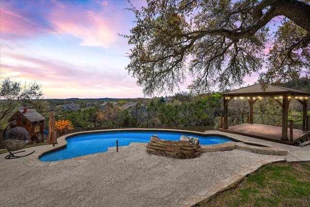 outdoor pool with a gazebo and a patio area