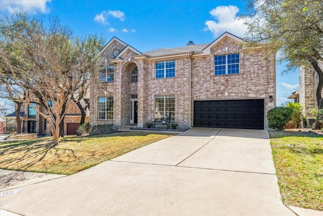 traditional home featuring concrete driveway, brick siding, a front lawn, a garage, and central air condition unit