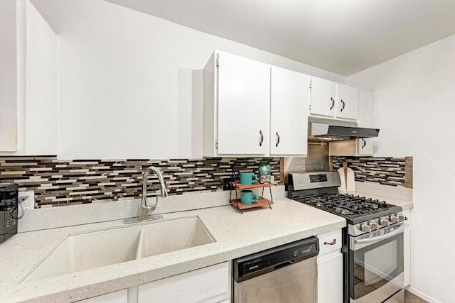 8610 Croydon Loop, Austin, TX 78748 - kitchen with appliances with stainless steel finishes, under cabinet range hood, tasteful backsplash, and white cabinets