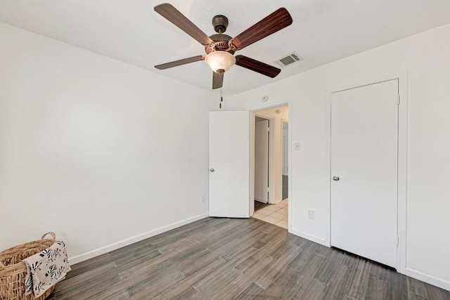 8610 Croydon Loop, Austin, TX 78748 - unfurnished bedroom with visible vents, baseboards, and wood finished floors