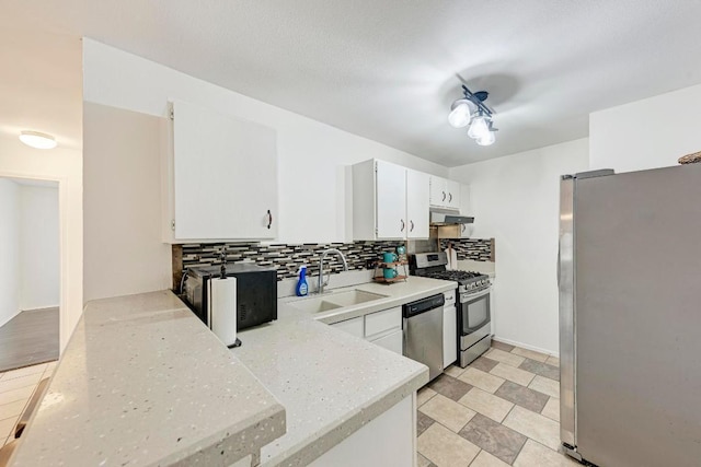 8610 Croydon Loop, Austin, TX 78748 - kitchen featuring stainless steel appliances, under cabinet range hood, decorative backsplash, white cabinetry, and light stone countertops