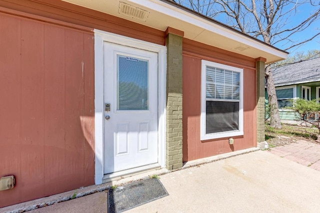 8610 Croydon Loop, Austin, TX 78748 - property entrance featuring brick siding, visible vents, and a patio area