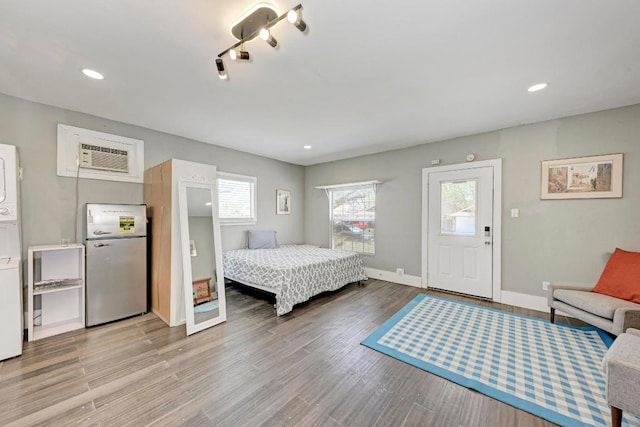 8610 Croydon Loop, Austin, TX 78748 - bedroom with baseboards, freestanding refrigerator, recessed lighting, and wood finished floors
