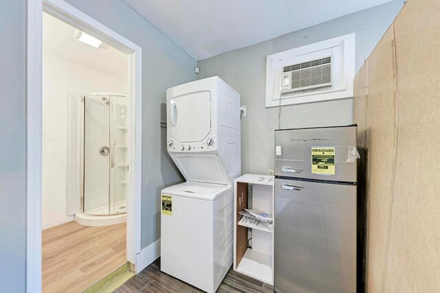 8610 Croydon Loop, Austin, TX 78748 - washroom featuring laundry area, stacked washer and dryer, wood finished floors, and a wall unit AC
