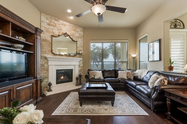 living room with recessed lighting, ceiling fan, dark wood-style floors, and a fireplace