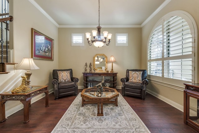 sitting room featuring dark wood-type flooring, crown molding, plenty of natural light, and a notable chandelier