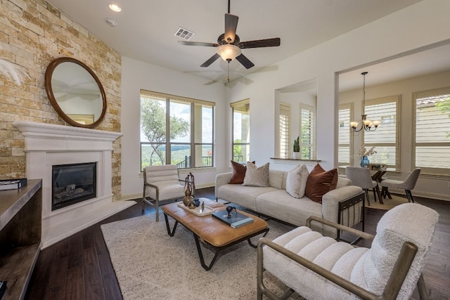 11521 Shadestone Ter, Austin, TX 78732 - living room featuring dark wood finished floors, a chandelier, ceiling fan, a glass covered fireplace, and recessed lighting
