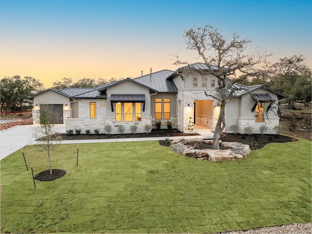 390 Crosswater Ln, Dripping Springs, TX 78620 - modern farmhouse featuring a standing seam roof, stone siding, concrete driveway, and a yard