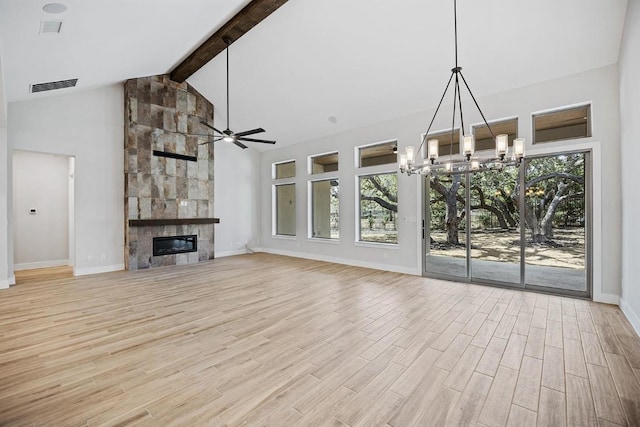 390 Crosswater Ln, Dripping Springs, TX 78620 - unfurnished living room with baseboards, a ceiling fan, light wood-style flooring, beam ceiling, and a large fireplace
