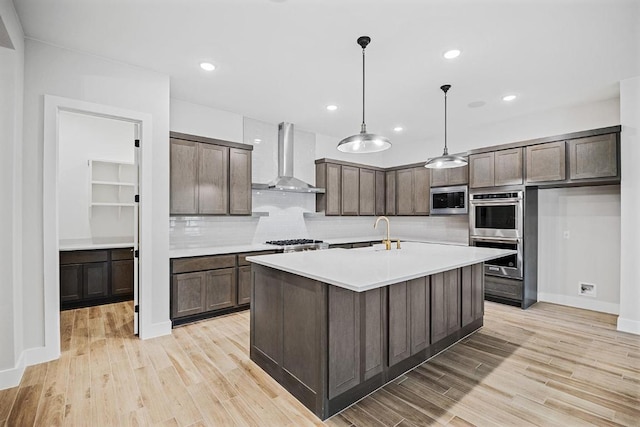 390 Crosswater Ln, Dripping Springs, TX 78620 - kitchen with wall chimney exhaust hood, stainless steel appliances, dark brown cabinets, decorative backsplash, and recessed lighting