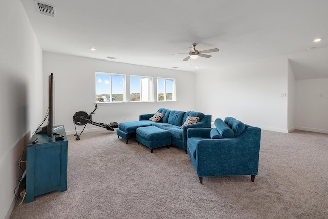 living room featuring a ceiling fan, light colored carpet, visible vents, and baseboards