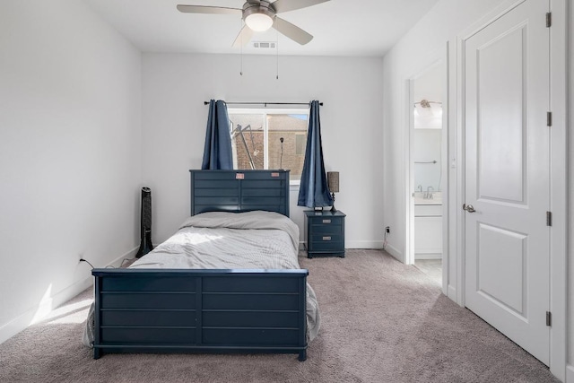 bedroom with baseboards, visible vents, carpet floors, ceiling fan, and connected bathroom
