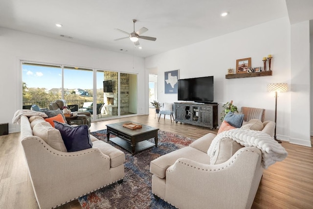 living area with recessed lighting, wood finished floors, and a ceiling fan