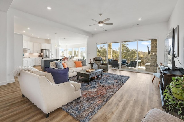living room featuring recessed lighting, light wood-style floors, and ceiling fan