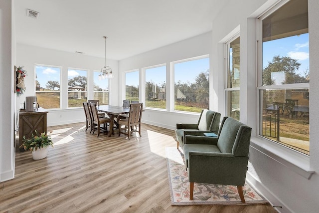 sunroom featuring a chandelier and visible vents