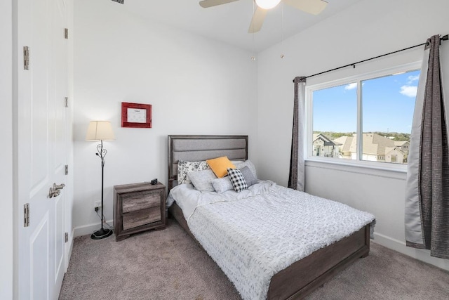 bedroom featuring baseboards, carpet floors, and a ceiling fan