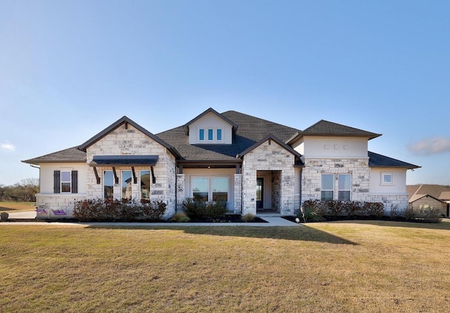 view of front facade with a front lawn, stone siding, and a shingled roof
