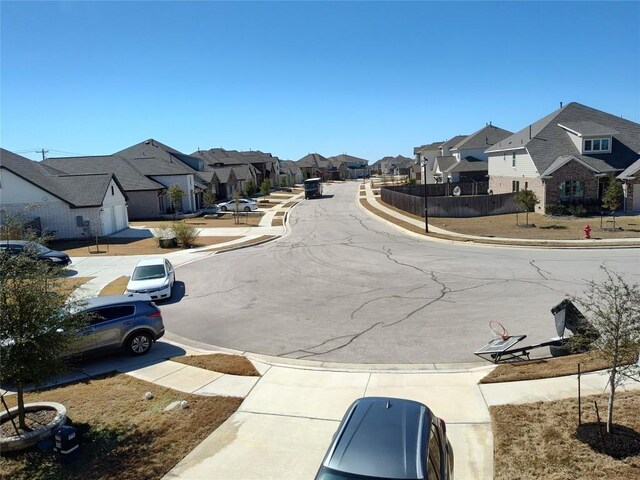 4336 Trey Edsel Dr, Pflugerville, TX 78660 - view of asphalt street with a residential view, sidewalks, and curbs