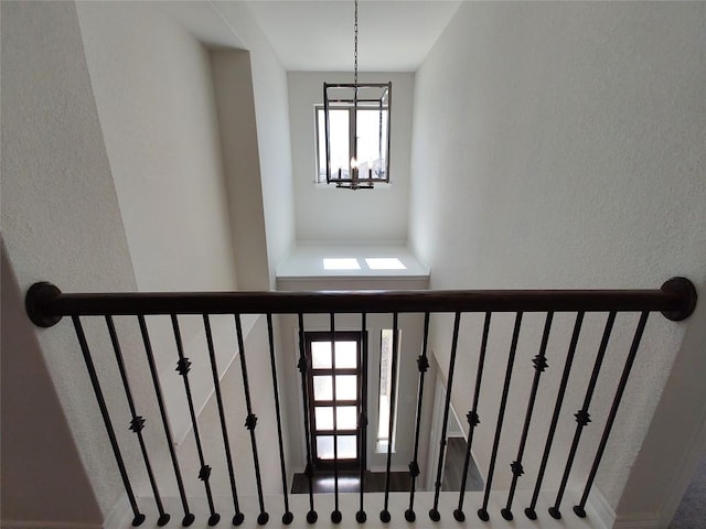 stairway with a chandelier