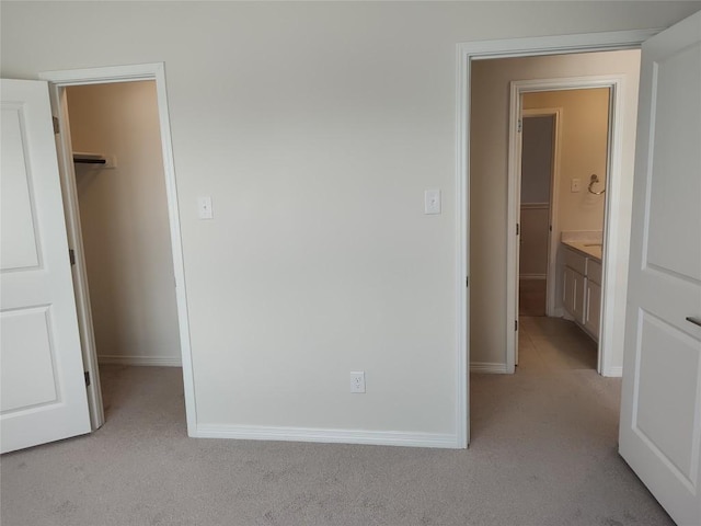 4336 Trey Edsel Dr, Pflugerville, TX 78660 - unfurnished bedroom featuring a walk in closet, light colored carpet, a closet, and baseboards