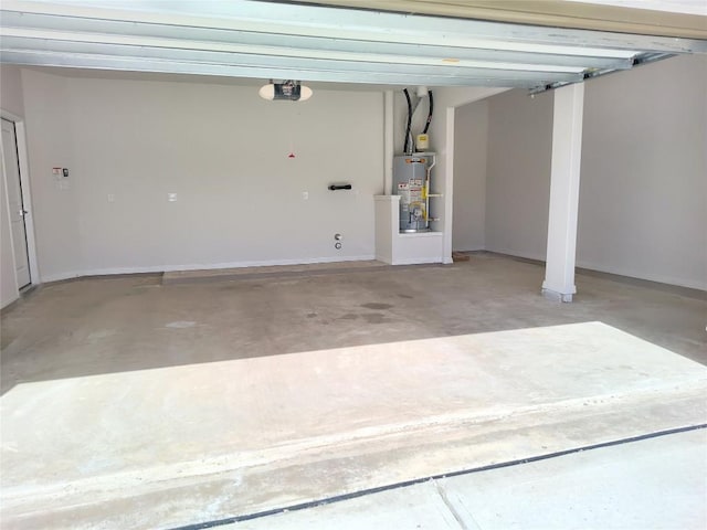 garage with gas water heater, a garage door opener, and baseboards