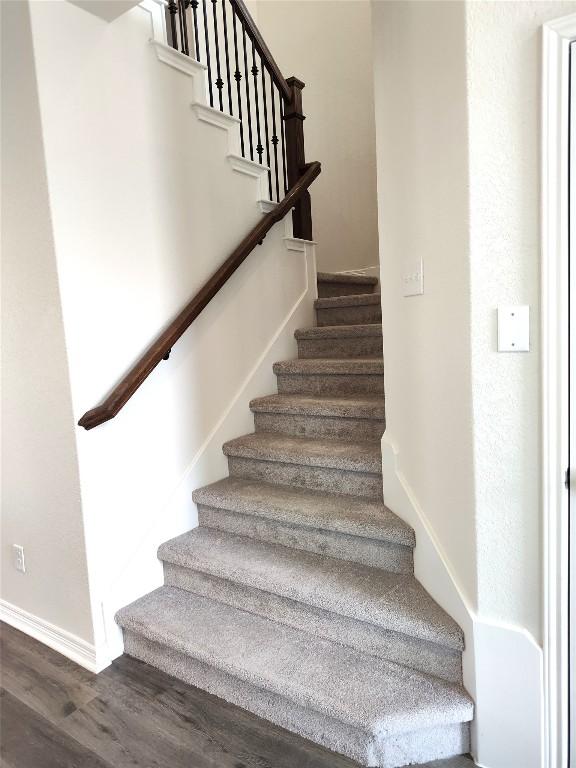 4336 Trey Edsel Dr, Pflugerville, TX 78660 - staircase with wood finished floors and baseboards