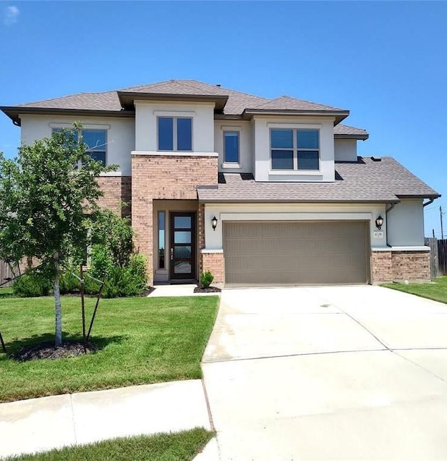 4336 Trey Edsel Dr, Pflugerville, TX 78660 - prairie-style home featuring brick siding, stucco siding, concrete driveway, and a front lawn