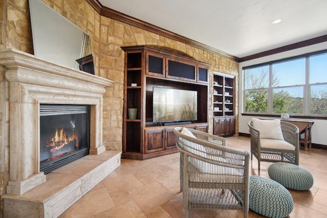 23617 Indian Divide Cv, Spicewood, TX 78669 - living area featuring ornamental molding, a glass covered fireplace, baseboards, and built in shelves