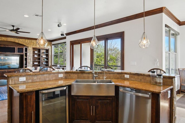 23617 Indian Divide Cv, Spicewood, TX 78669 - kitchen with dishwasher, beverage cooler, open floor plan, a sink, and ornamental molding