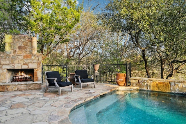 23617 Indian Divide Cv, Spicewood, TX 78669 - view of pool featuring an outdoor stone fireplace and a patio